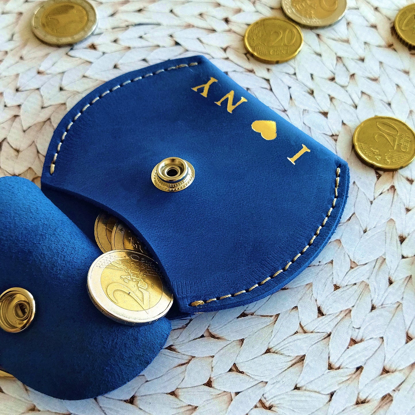 Close-up of custom engraved leather coin pouch with personalized initials