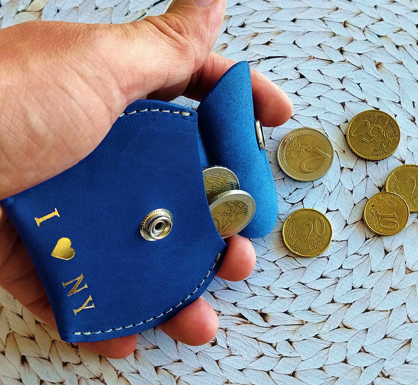 Leather coin pouch with zipper, providing secure storage for coins and small items