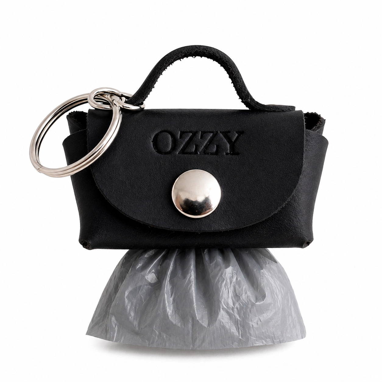 Black handbag-shaped keychain with 'Ozzy' branding and a plastic bag on a white background
