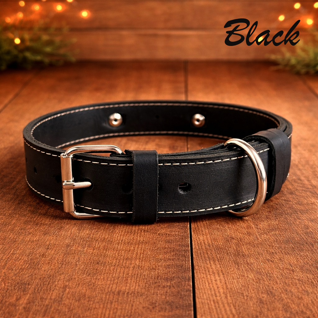 Black leather dog collar with silver buckle on a wooden surface, labeled 'Black'.