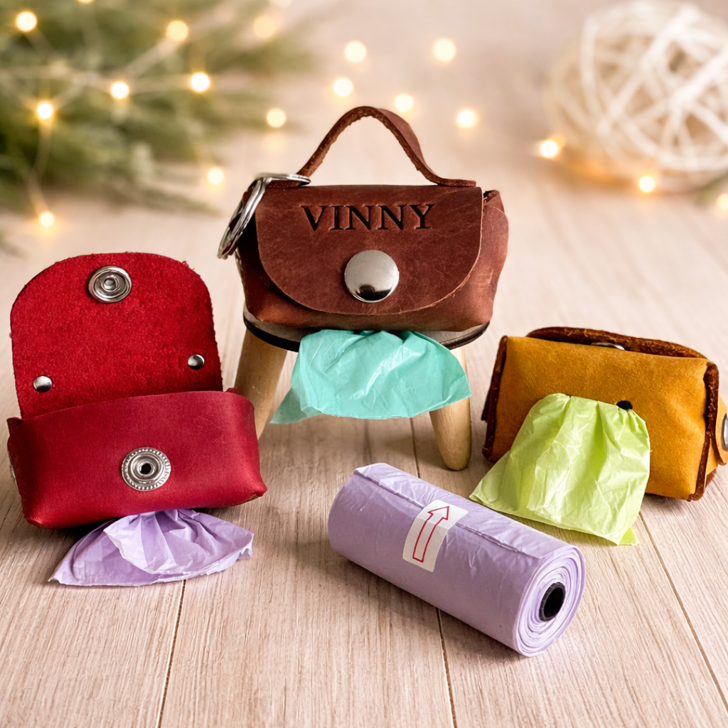 Colorful fabric bags and a roll of paper on a wooden surface with a blurred decorative background.
