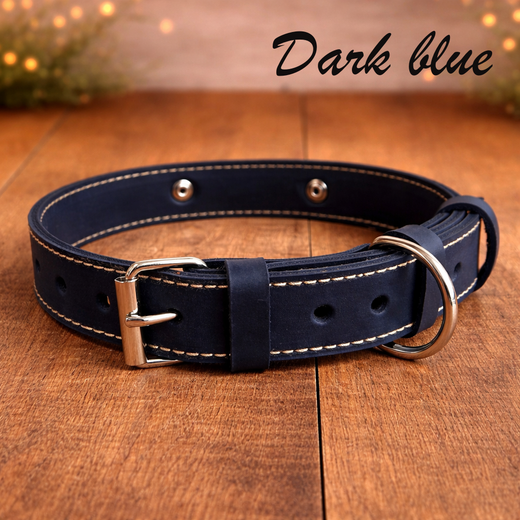 Dark blue leather dog collar with silver buckle on a wooden surface, labeled 'Dark blue'.