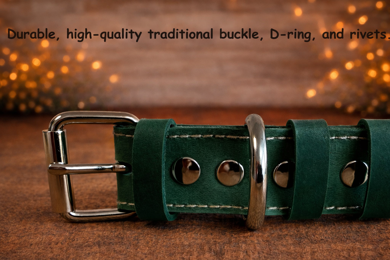 Green leather belt with metal buckle and D-ring on a wooden surface.