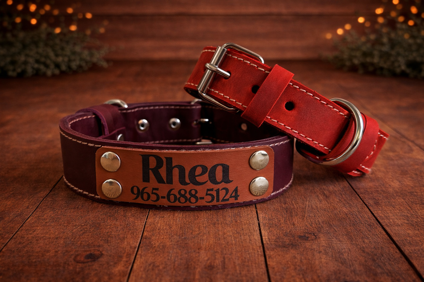 Two leather dog collars, one red and one brown, on a wooden surface.