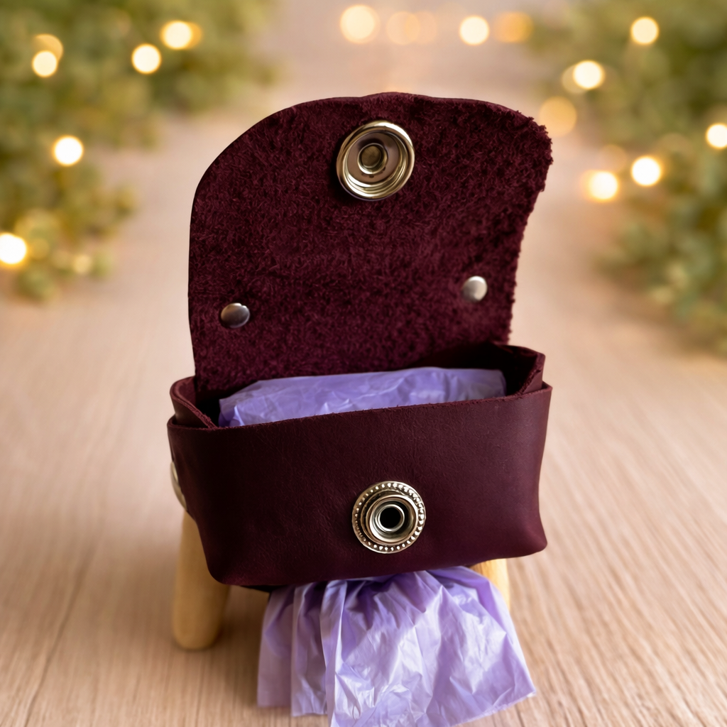 Purple decorative box with metallic accents on a wooden surface with blurred lights in the background