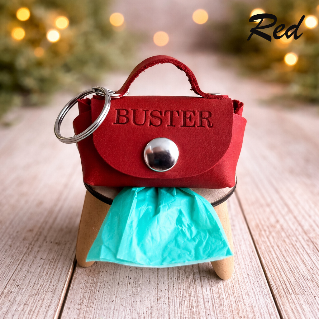 Red dog toy with 'BUSTER' branding on a wooden stand, blurred lights in the background