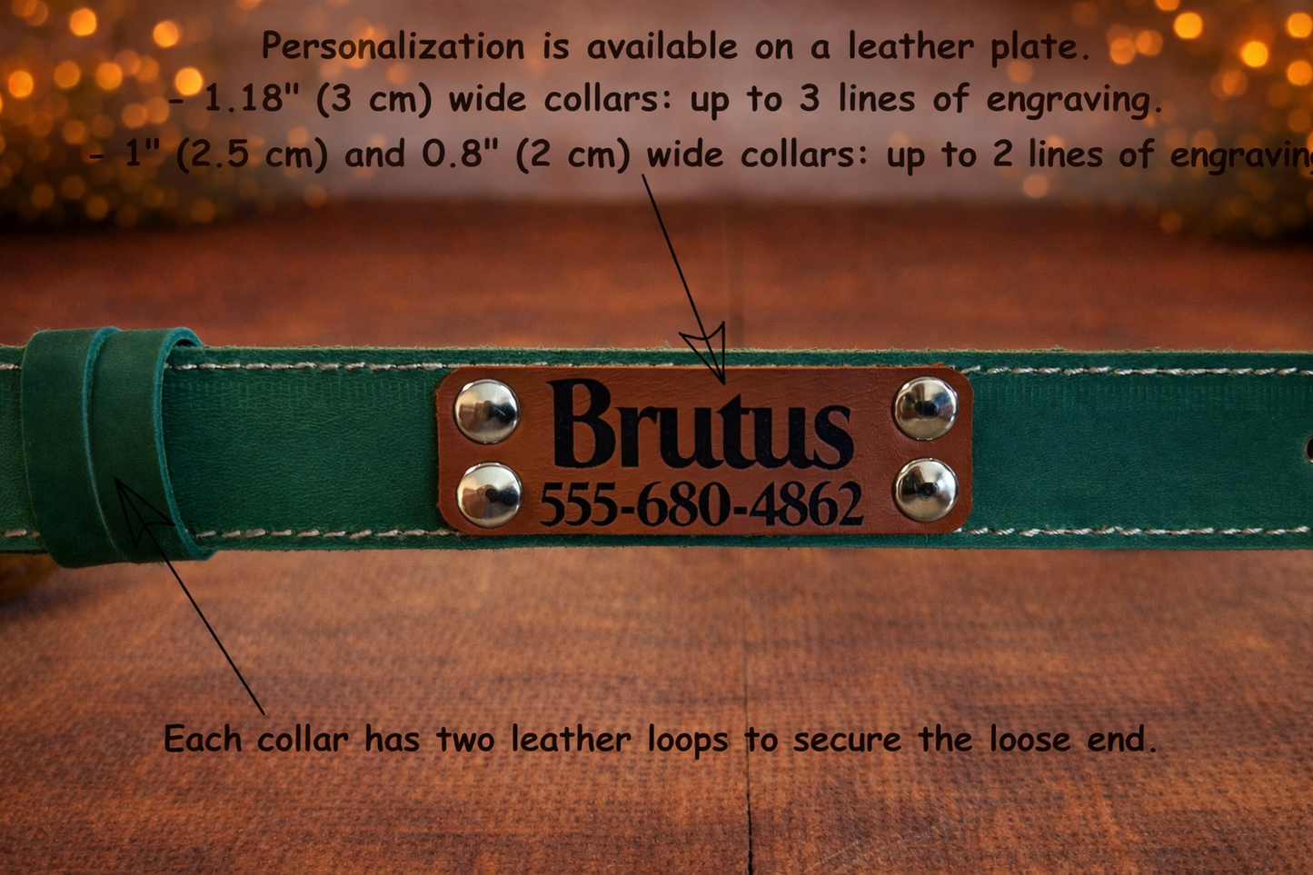 Green leather dog collar with engraved nameplate on a wooden surface