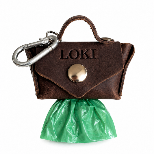 Brown leather keychain with 'LOKI' branding and a green plastic bag on a white background