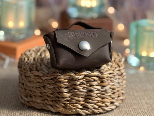Compact leather poop bag holder designed to fit standard poop bags and small dog essentials