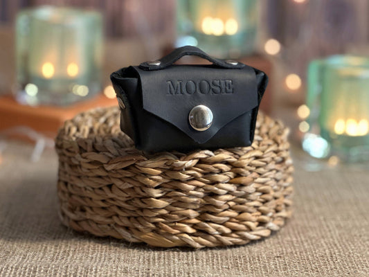 Stylish leather dog poop bag holder with a bell attached for easy access during walks