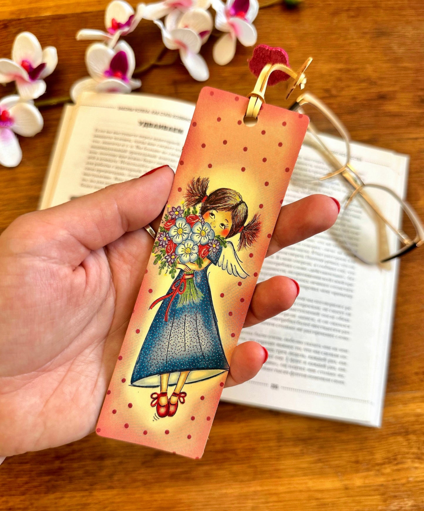 Floral print leather bookmark resting next to a stack of books, perfect for adding elegance to your reading routine