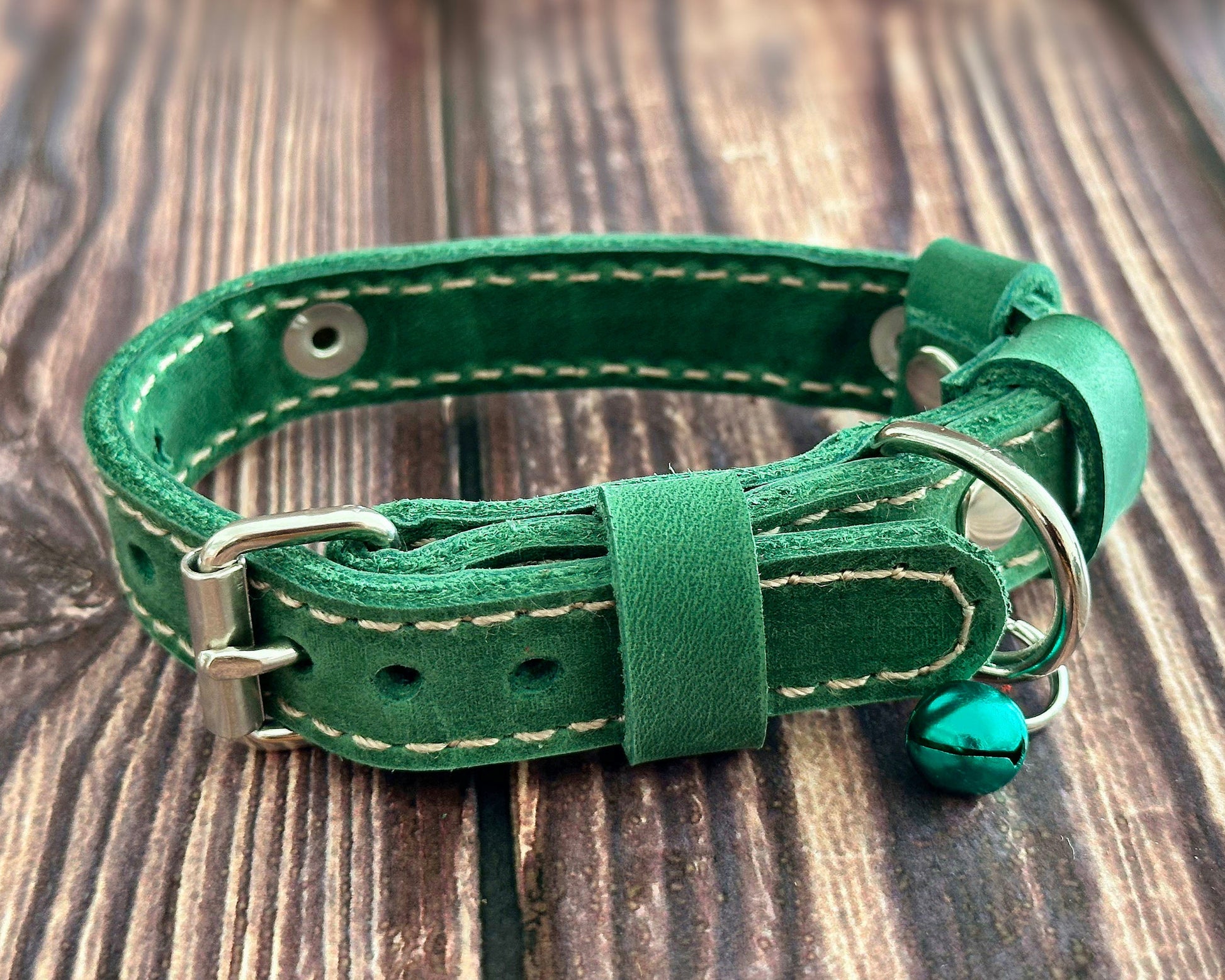 Handmade leather cat collar with custom personalization, available in multiple colors.