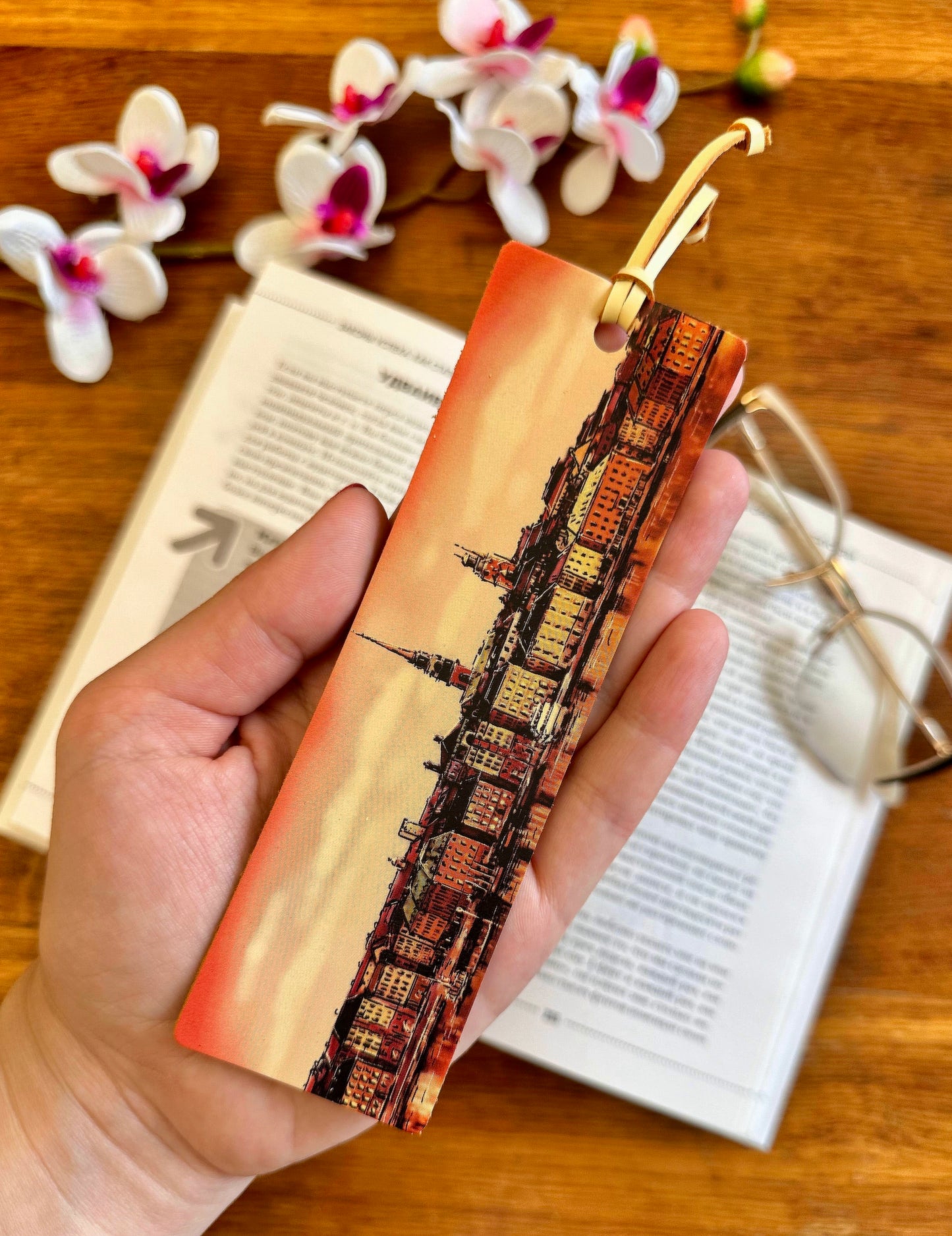 Leather bookmark placed in a classic novel, enhancing the reading experience with its stylish and functional design
