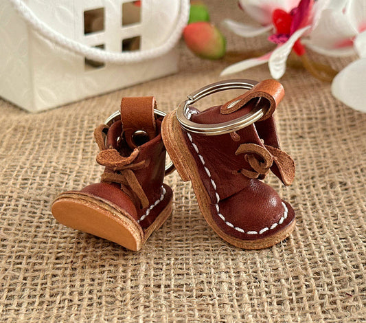 Close-up of a leather boot keychain showing its fine texture and stitching