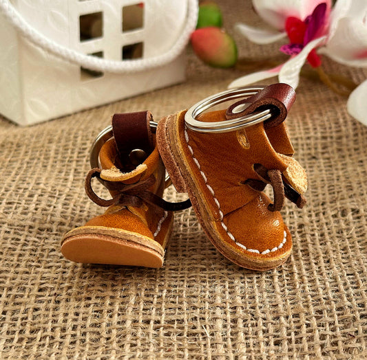 Vintage leather boot keychain with a distressed finish, giving it a timeless, rugged charm
