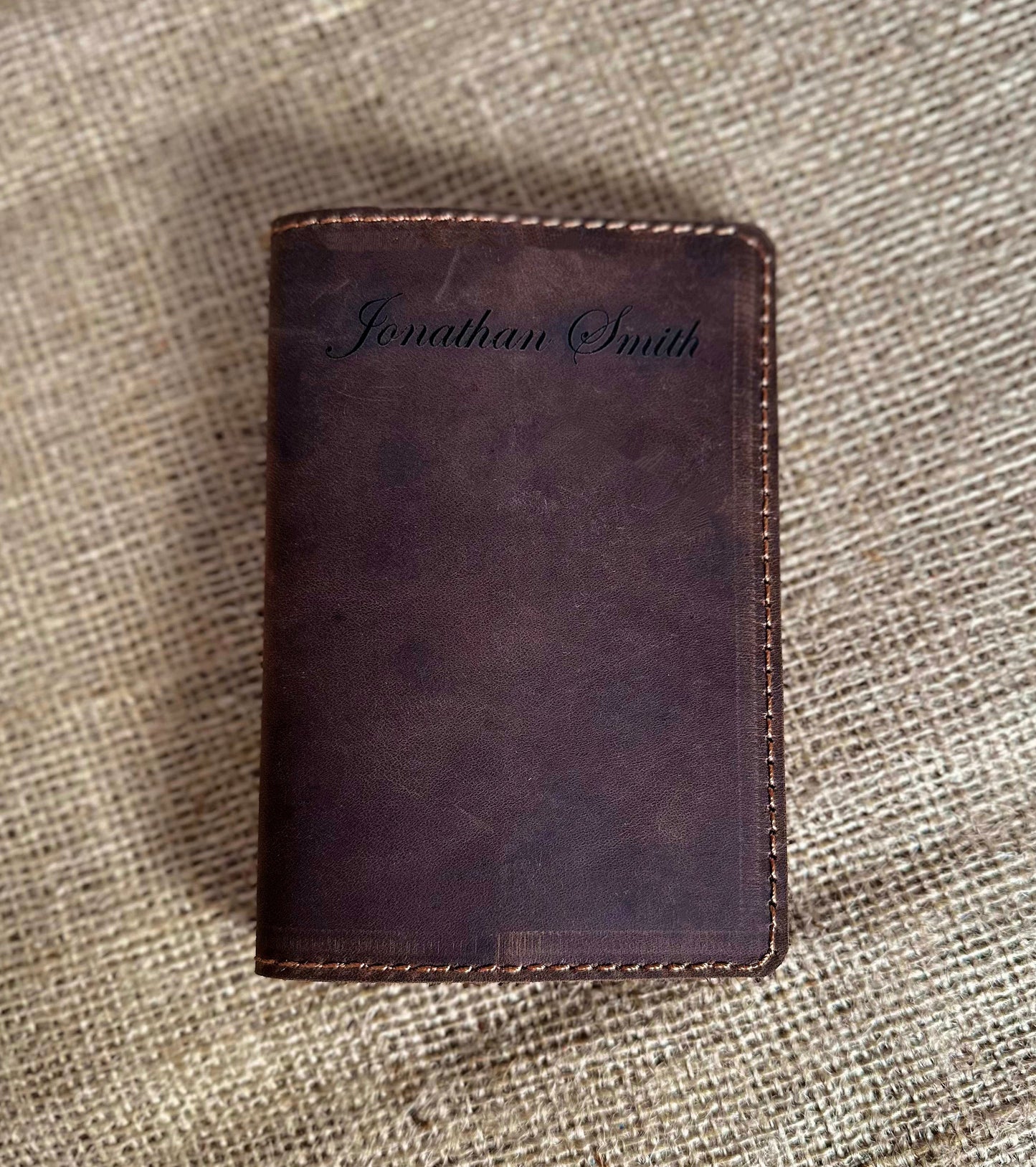 Flat lay of travel items with leather passport case