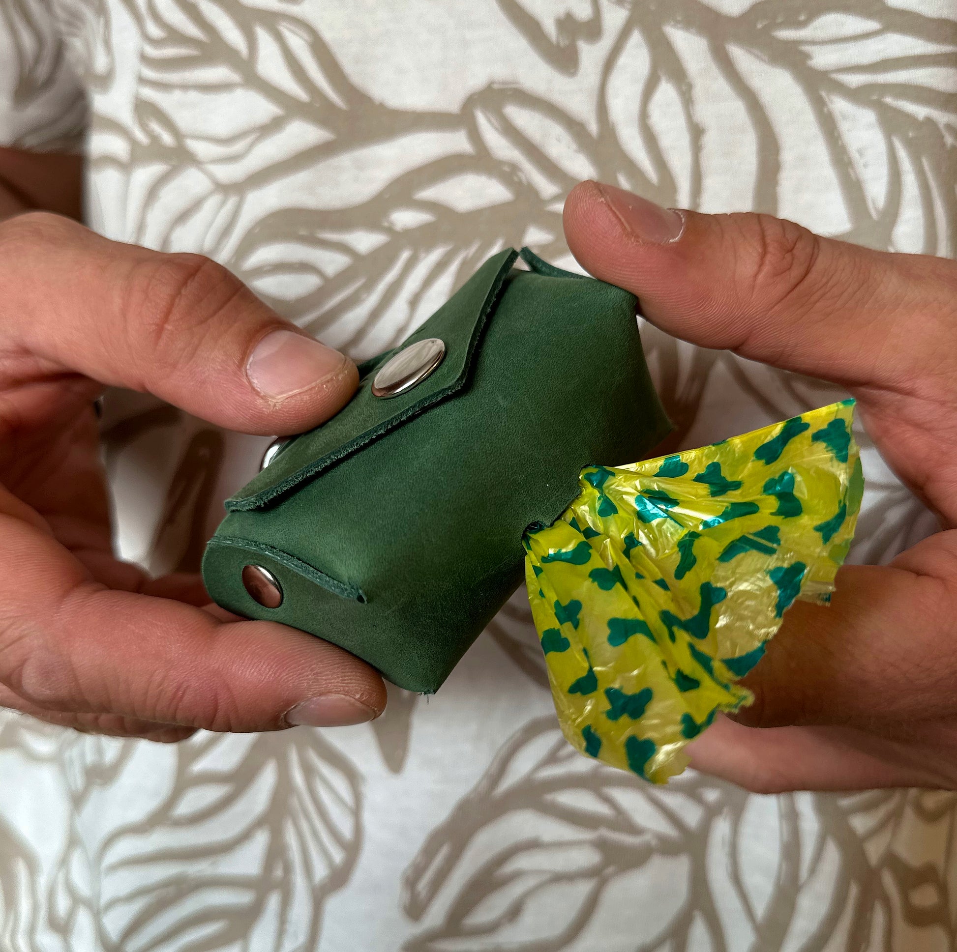 Side view of the leather poop bag dispenser, showcasing its sleek, compact design and high-quality leather