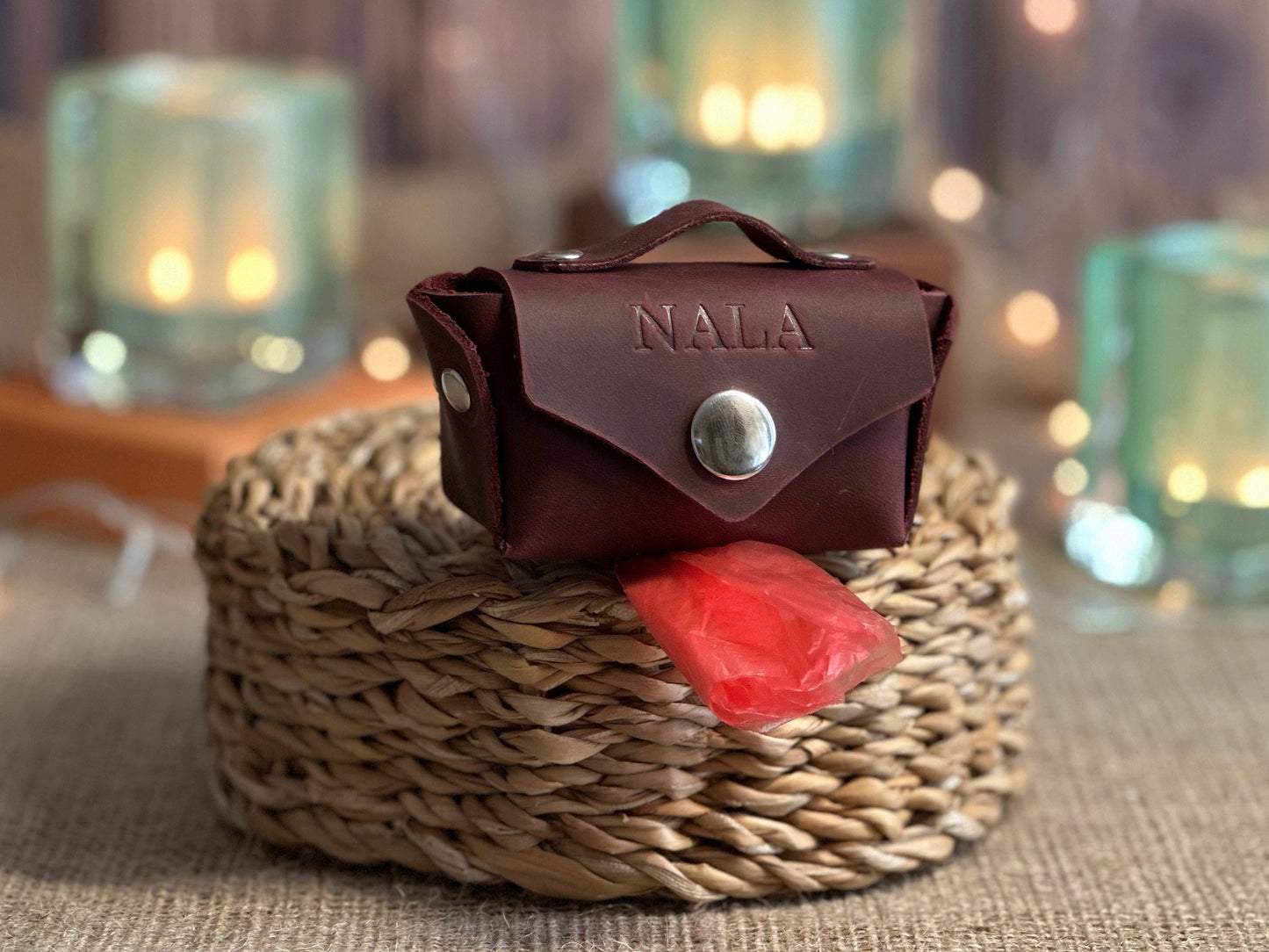 Leather poop bag holder with sturdy carabiner attached to dog leash for easy access
