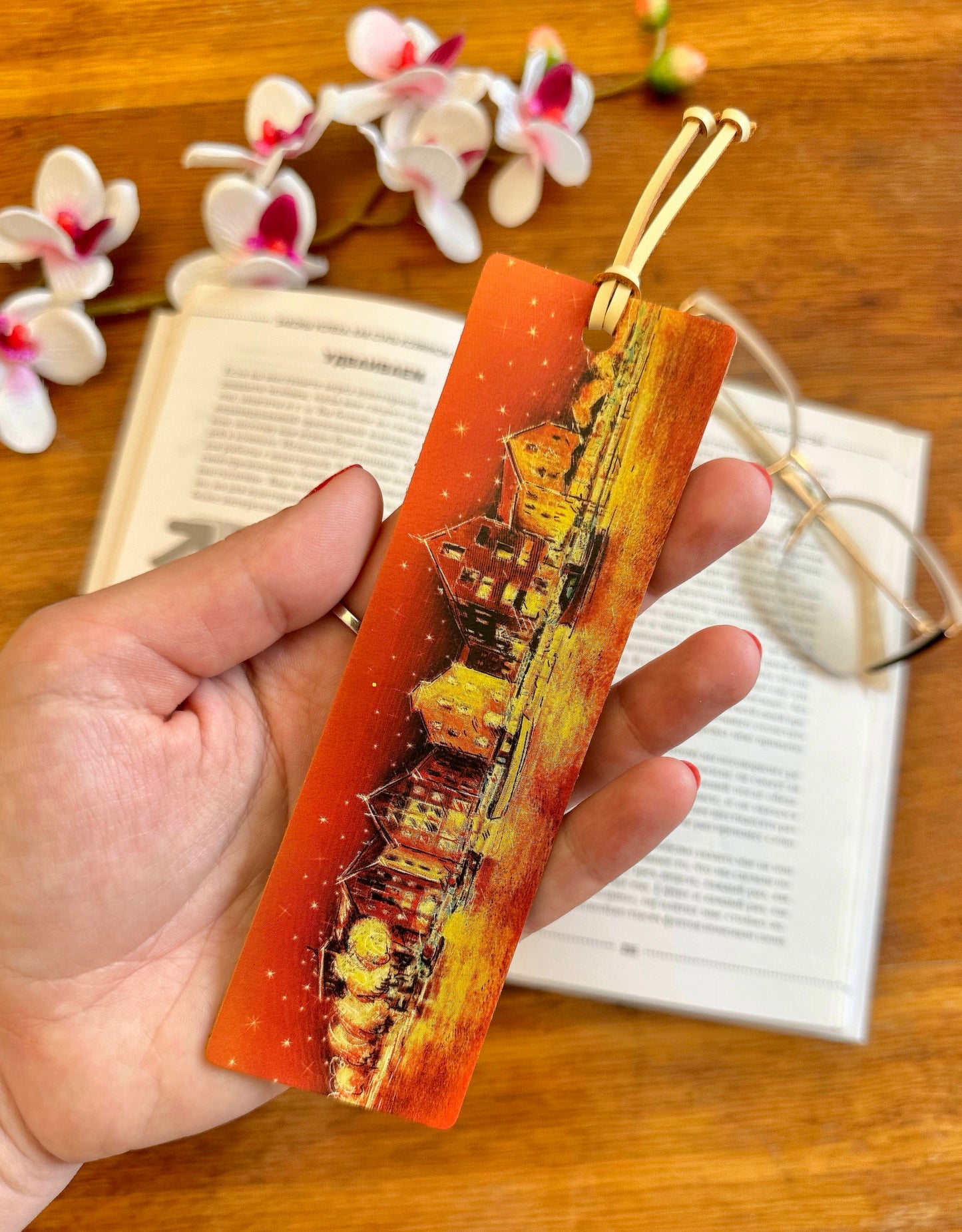 Personalized leather bookmark inside a book gift set, offering a thoughtful and elegant present for any occasion