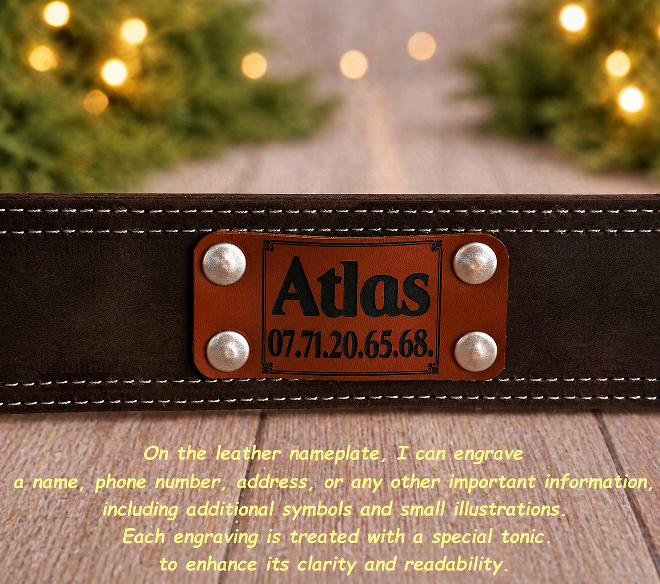 Brown leather belt with a nameplate labeled 'Atlas' on a wooden surface with blurred lights in the background.
